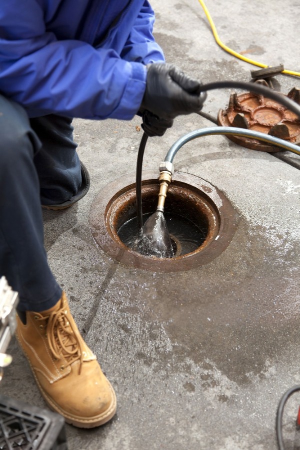 technician hydro jetting clogged drain line